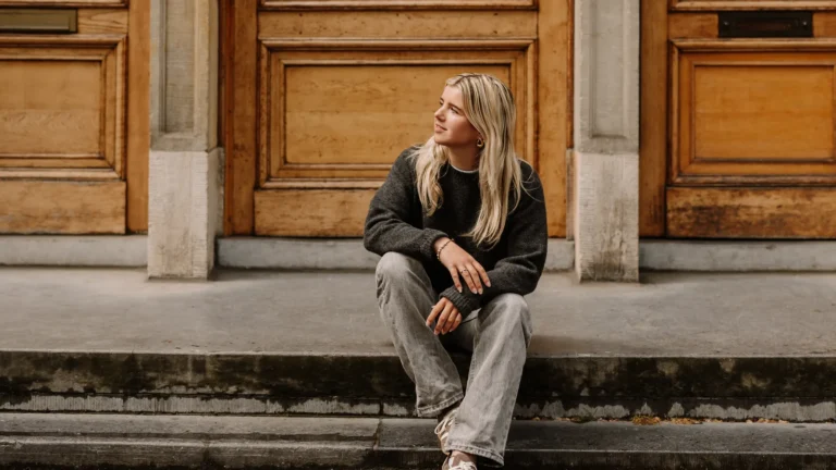 Lisa, makelaar bij Makelaar in Amsterdam, op de stoep voor een grachtenpand